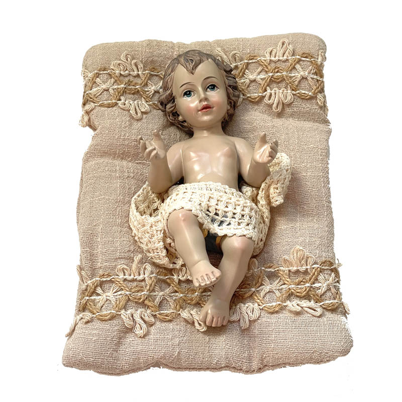 Figura del Niño Jesús con cojín de tela color beige